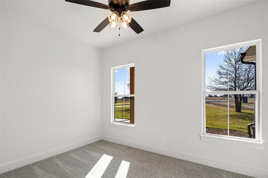 Unfurnished bedroom with ceiling fan, light colored carpet, and a closet