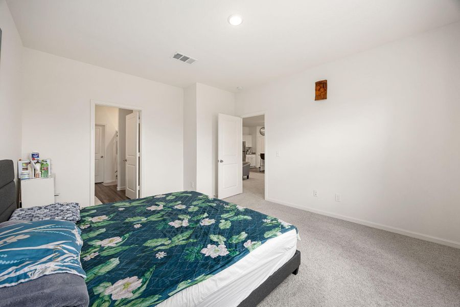 Private primary suite located at the back of the home.