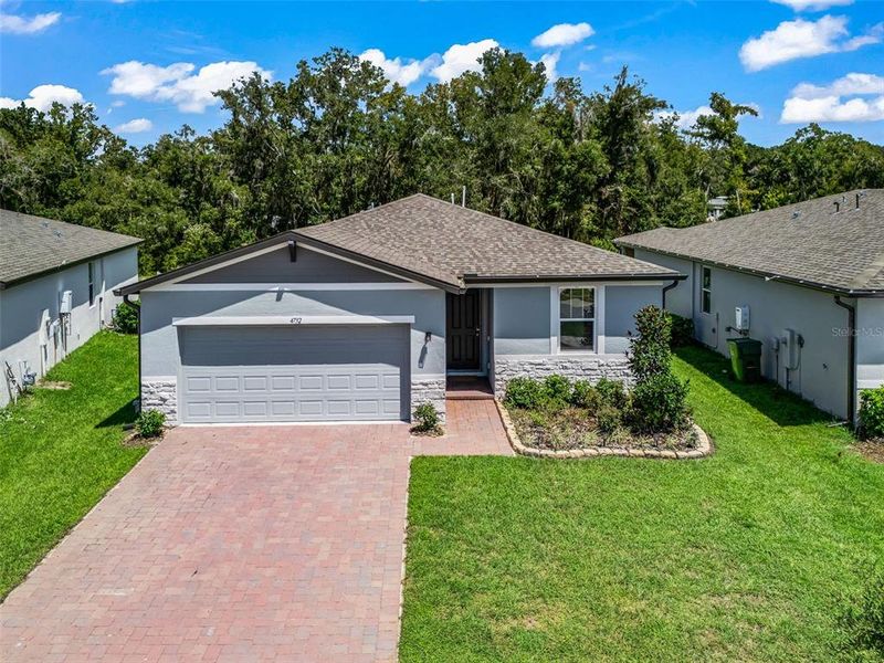 Front exterior of a new home in Fox Pointe at Rivers Edge, Leesburg, FL, highlighting curb appeal (Image 21).
