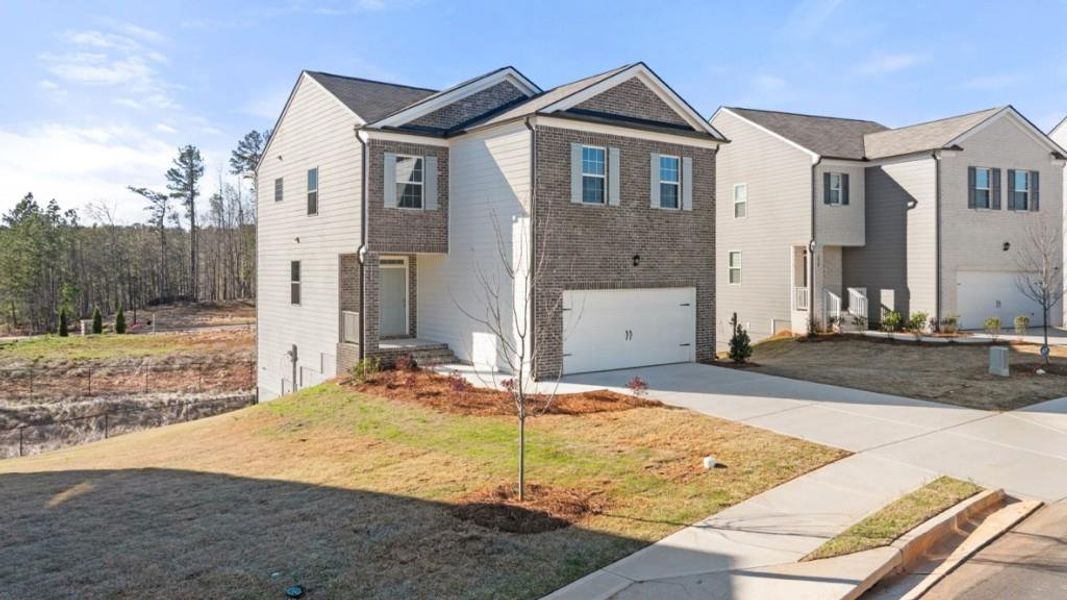 Front exterior of a new home in Pointe Park, Union City, GA, highlighting curb appeal (Image 1). Front exterior of a new home in Pointe Park, Union City, GA, highlighting curb appeal (Image 1).