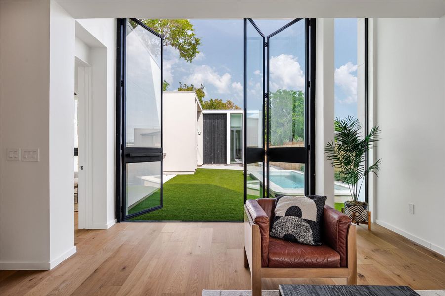 Living area with wood finished floors and expansive windows