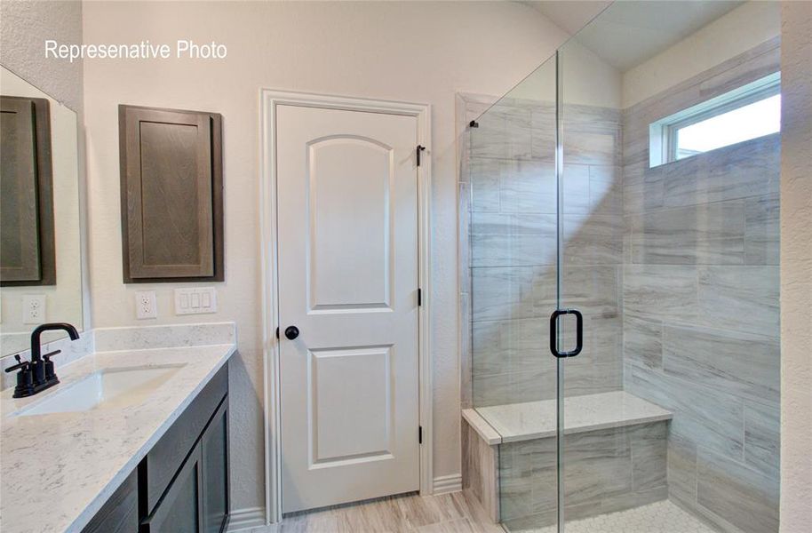 Modern bathroom featuring a walk-in shower with a glass enclosure, horizontal tiled walls, and a built-in bench