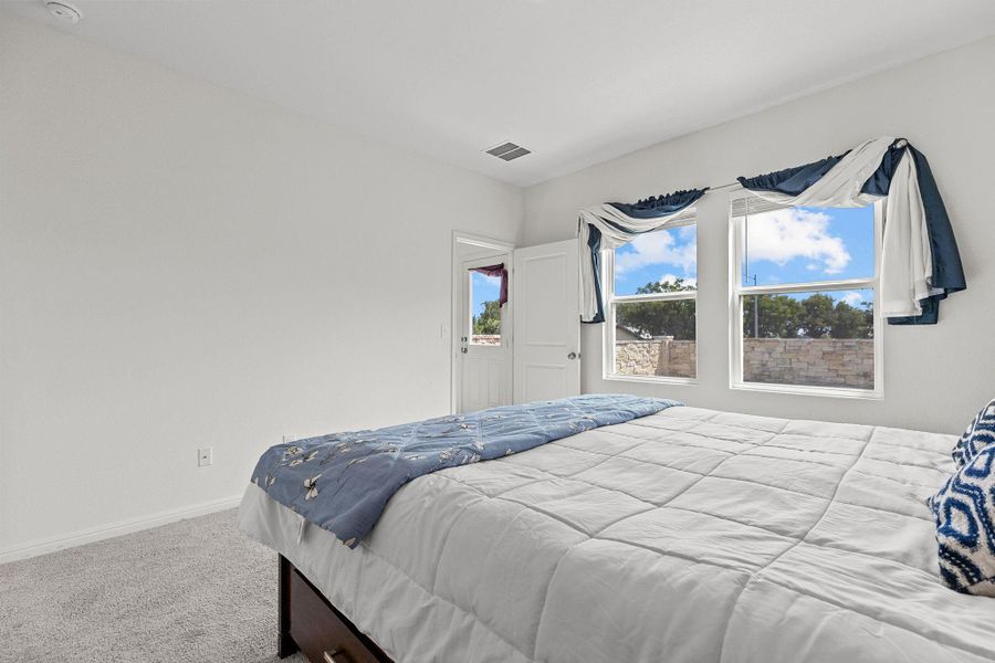 Carpeted bedroom with baseboards Carpeted bedroom with baseboards