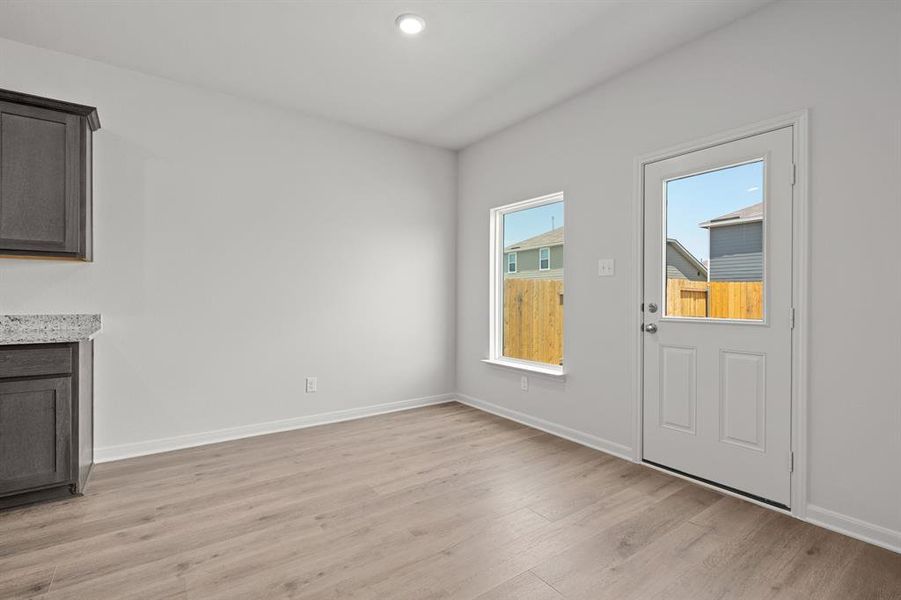 Unfurnished dining area featuring light wood finished floors and recessed lighting Unfurnished dining area featuring light wood finished floors and recessed lighting