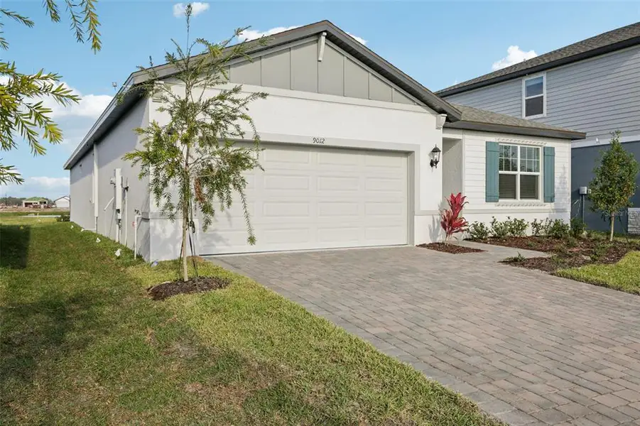 Front exterior of a new home in Coasterra - Reserve Series, Palmetto, FL, highlighting curb appeal (Image 1). Front exterior of a new home in Coasterra - Reserve Series, Palmetto, FL, highlighting curb appeal (Image 1).