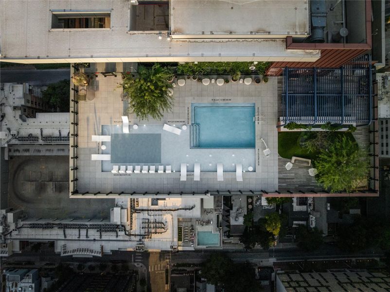 A rooftop oasis with a sparkling pool and lounging areas offers elevated urban living.
