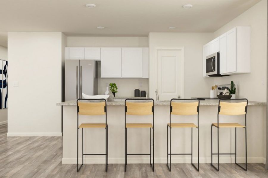A kitchen with white cabinets.