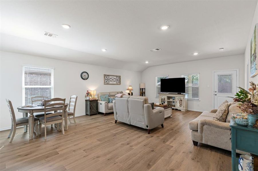 Spacious open-layout living area with modern recessed lighting and seamless flow into the kitchen and dining spaces. Spacious open-layout living area with modern recessed lighting and seamless flow into the kitchen and dining spaces.