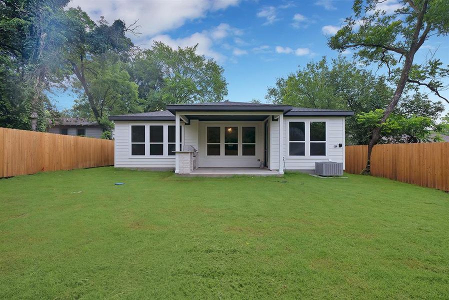 Expansive green lawn with a newly installed wood privacy fence Expansive green lawn with a newly installed wood privacy fence