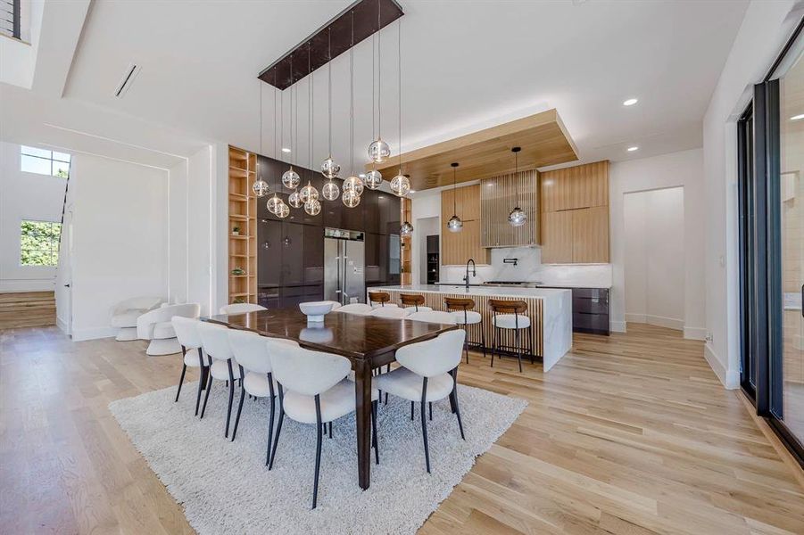 Dining space with light wood-type flooring, built in features, and recessed lighting Dining space with light wood-type flooring, built in features, and recessed lighting