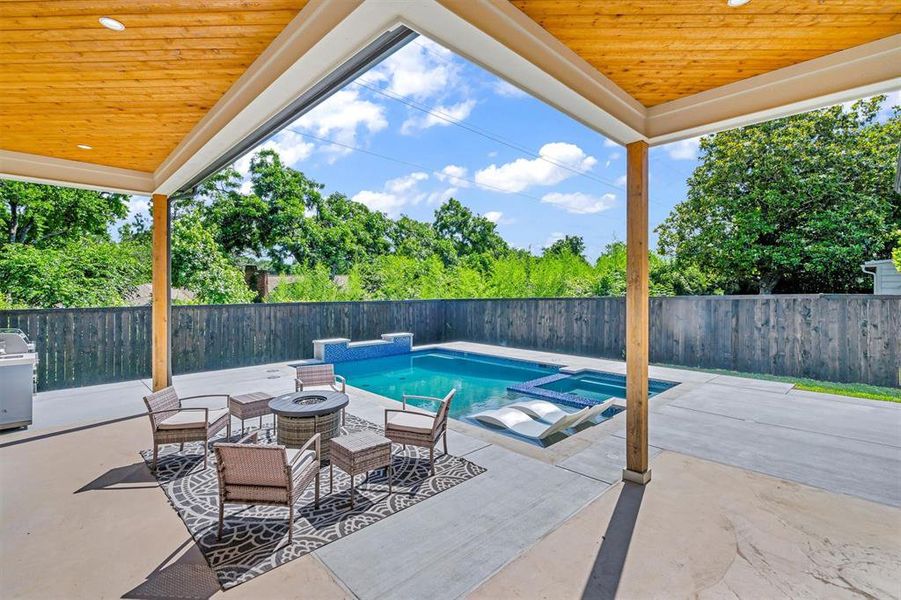 View of swimming pool featuring an in ground hot tub and a patio area