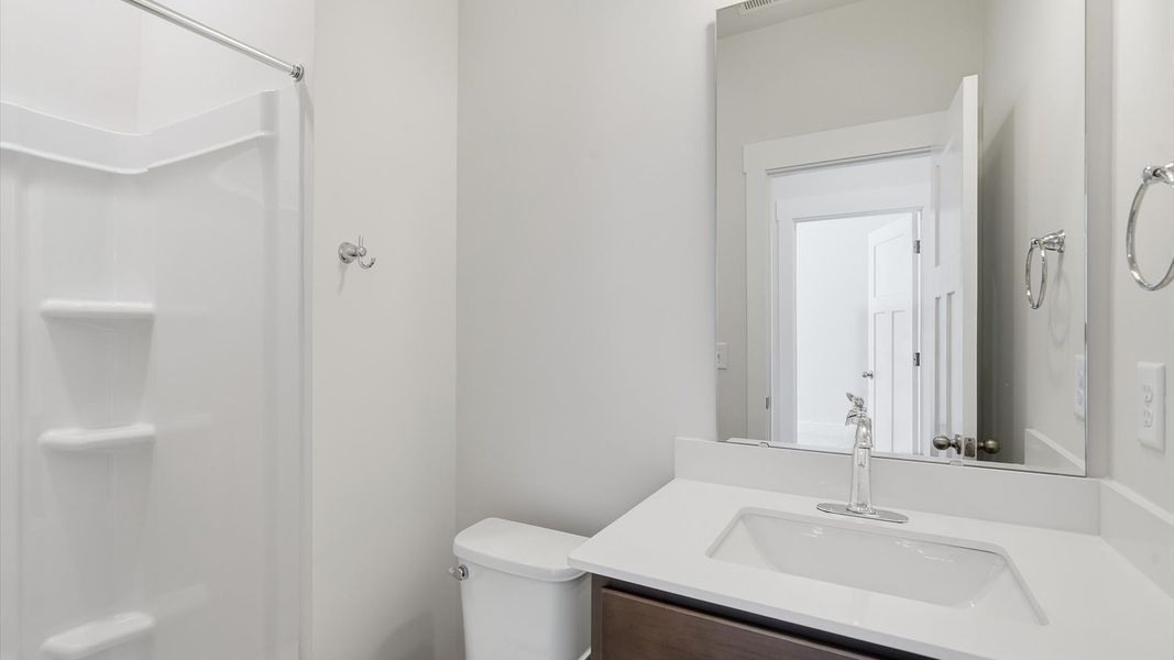 Refined hall bath with elevated finishes and a highly functional layout by DRB Homes