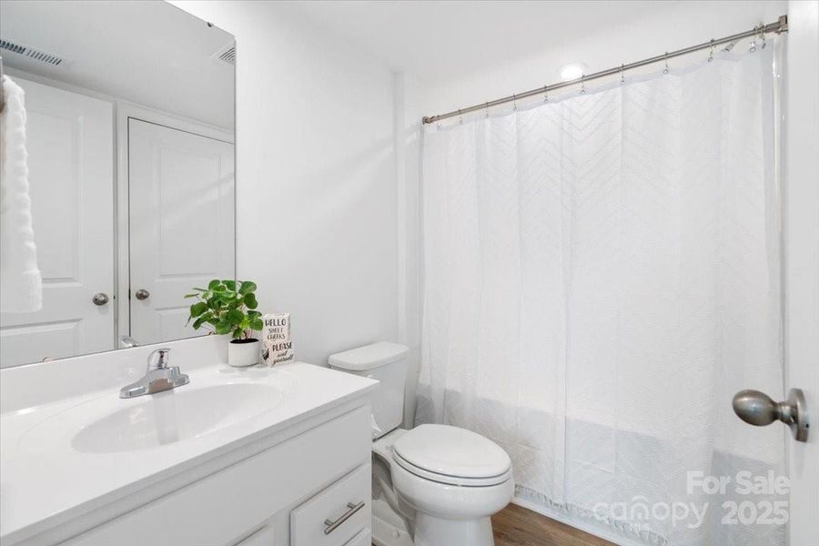 Lower level en suite bathroom with a large closet for more storage