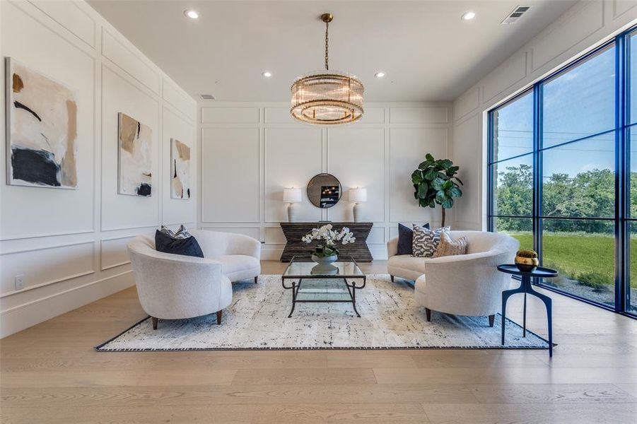 Living room featuring a chandelier and light hardwood / wood-style flooring