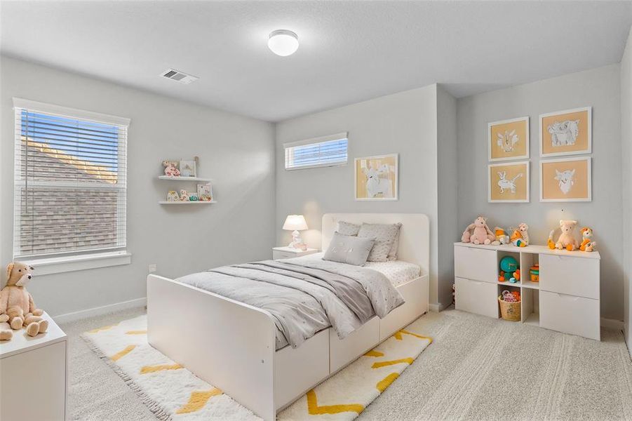 Secondary bedroom features plush carpet, custom paint, high ceilings, and a large window with privacy blinds.