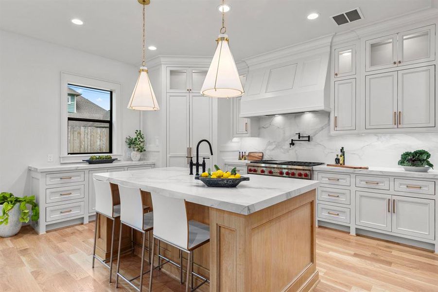 Chef's Kitchen comes equipped with Quartz backsplash, Pot Filler, Wolf Range w/ double oven & Vent hood.