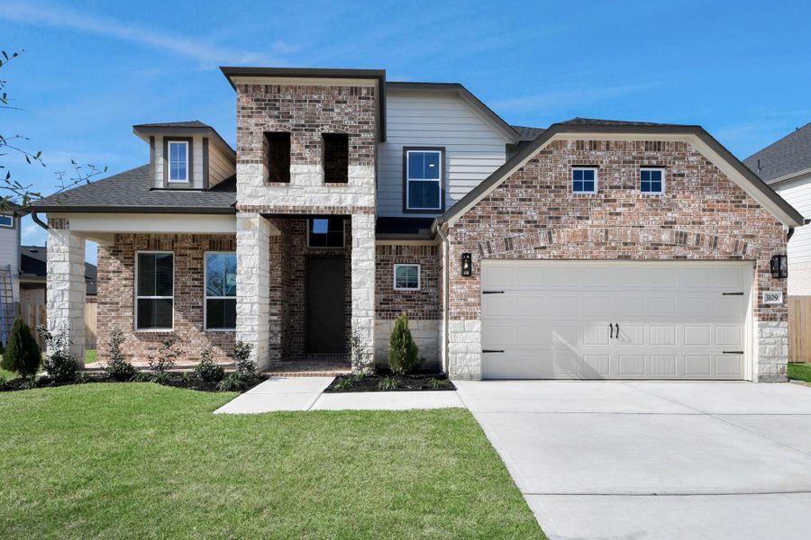 This home boasts lush green grass and meticulous landscaping. Its premium elevation showcases an exquisite blend of brick and stone features, complemented by modern coach lighting