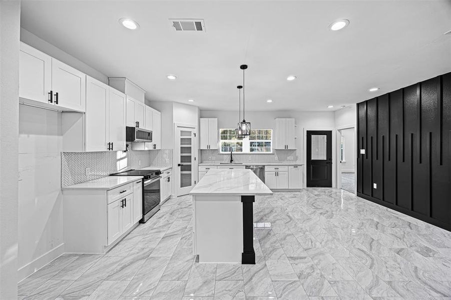 Kitchen with ample storage and stainless-steel appliances