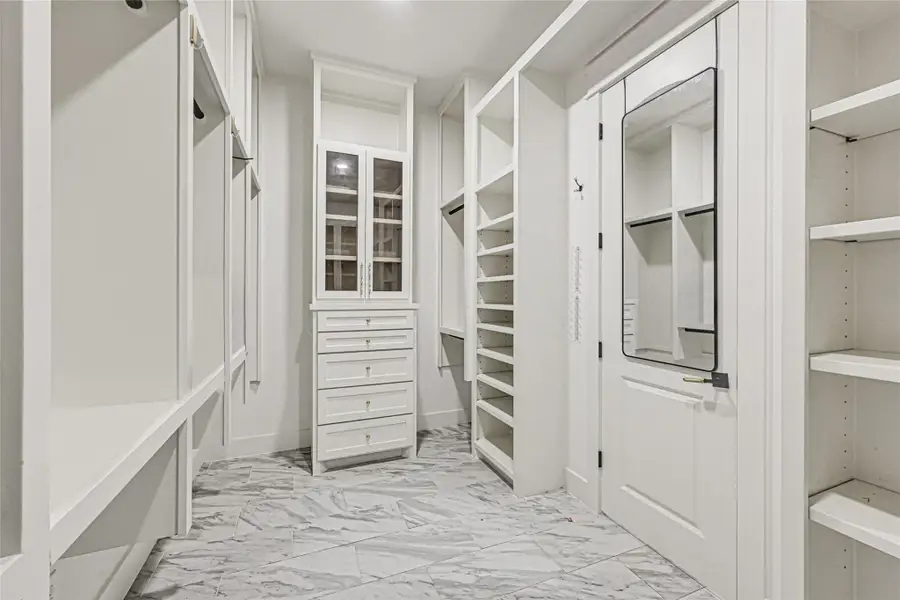 Primary bedroom walk in closet