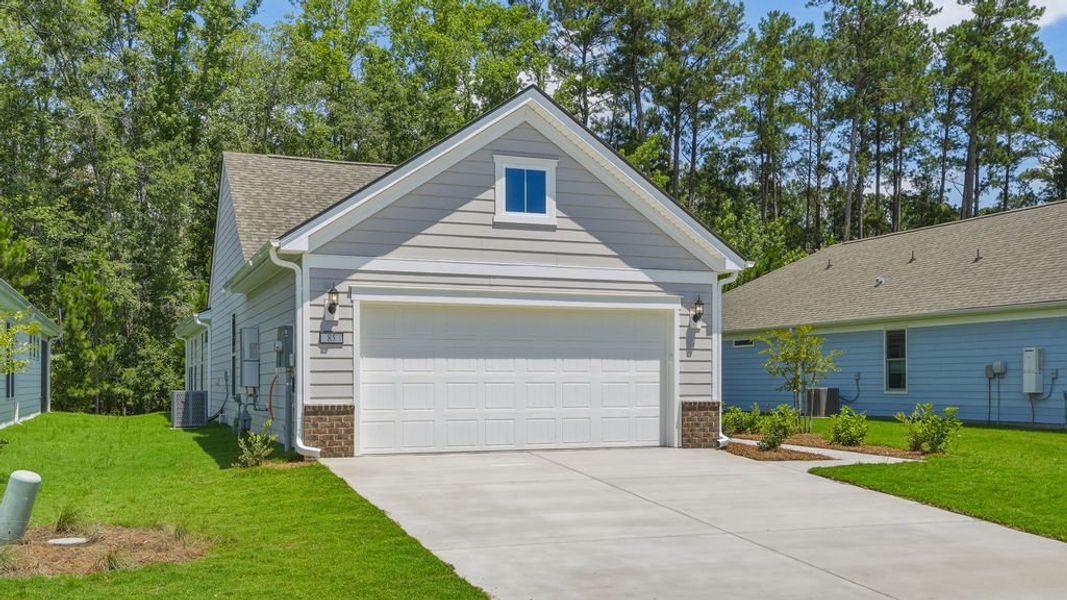 Front exterior of a new home in Sun City Hilton Head, Bluffton, SC, highlighting curb appeal (Image 26). Front exterior of a new home in Sun City Hilton Head, Bluffton, SC, highlighting curb appeal (Image 26).