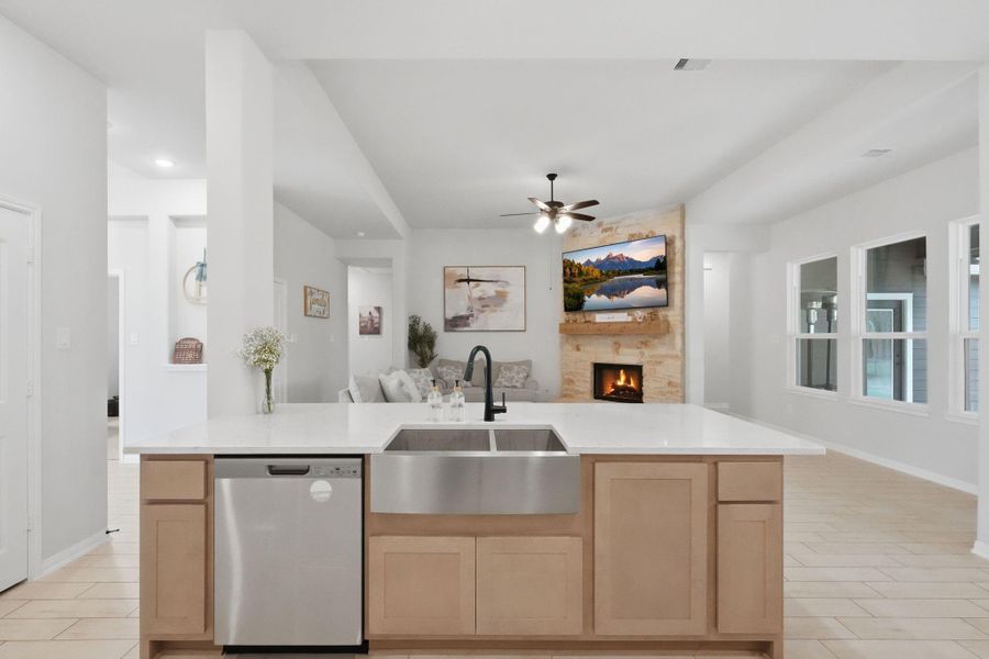 Open-concept kitchen with a large island overlooking the main living area, perfect for staying connected while cooking.