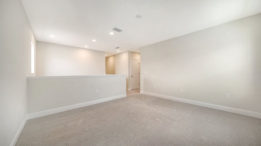 Spacious, unfurnished interior of a new home in Palm Grove Real Estate and Homes for Sale in Lakewood Ranch, FL - Neal Communities, Bradenton (Image 9).