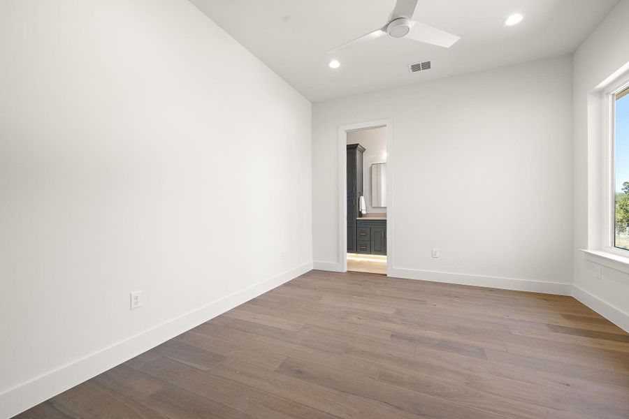 Unfurnished room featuring a ceiling fan, baseboards, wood finished floors, and recessed lighting