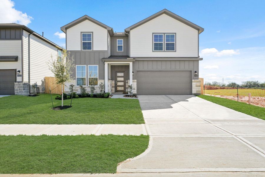 Front exterior of a new home in Paloma at Sanford Farms, Waller, TX, highlighting curb appeal (Image 1). Front exterior of a new home in Paloma at Sanford Farms, Waller, TX, highlighting curb appeal (Image 1).