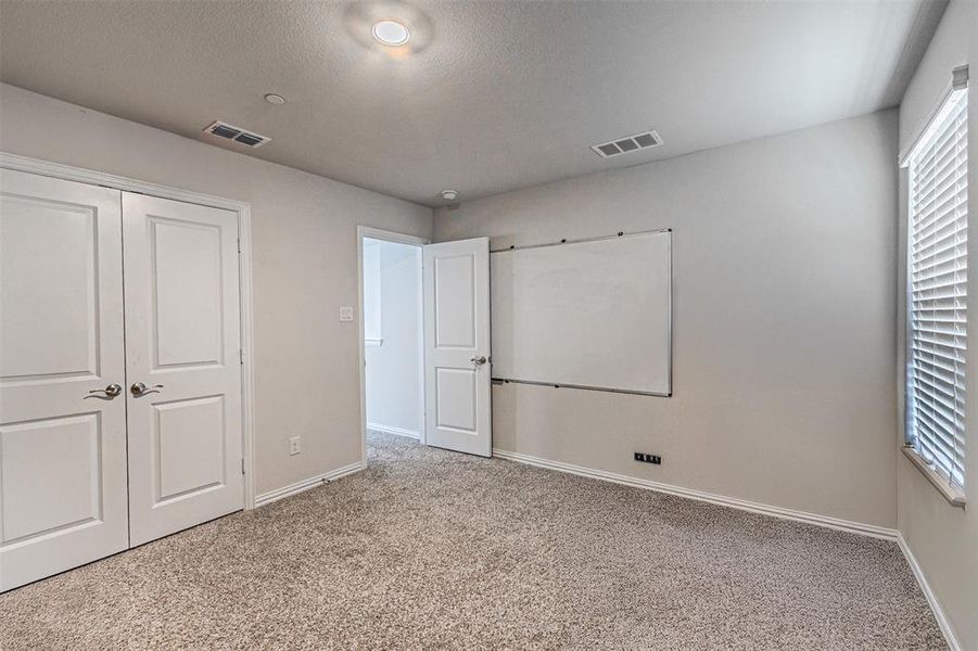 4th bedroom featuring carpet, visible vents, a closet, and baseboards