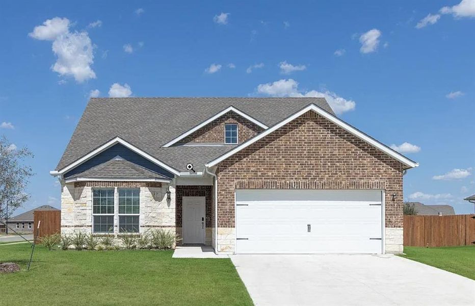 View of front of house with a garage and a front yard