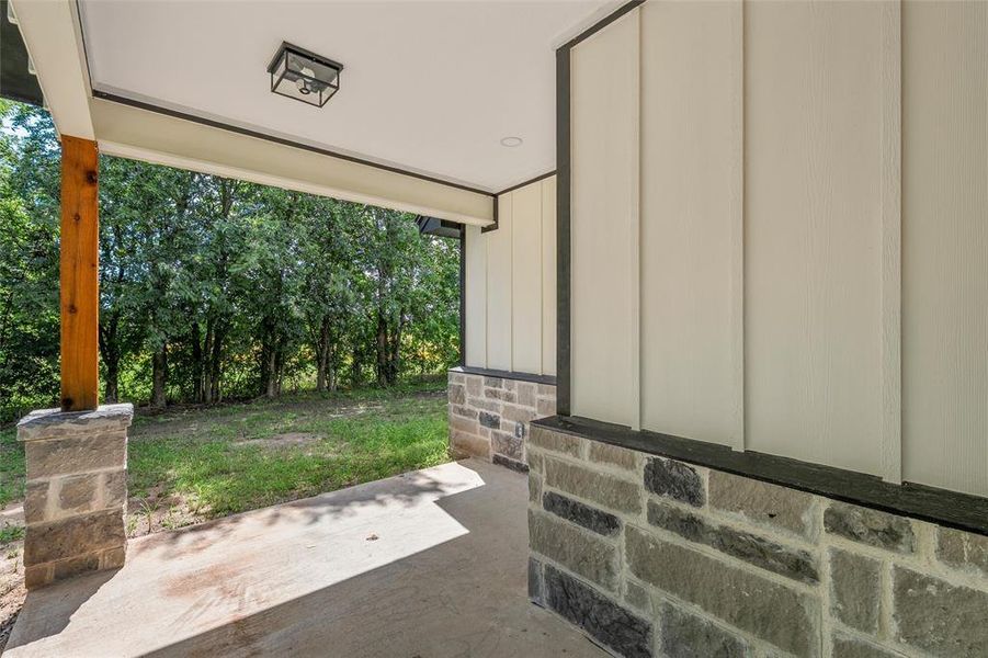 Covered porch with concrete flooring and a wood support beam Covered porch with concrete flooring and a wood support beam