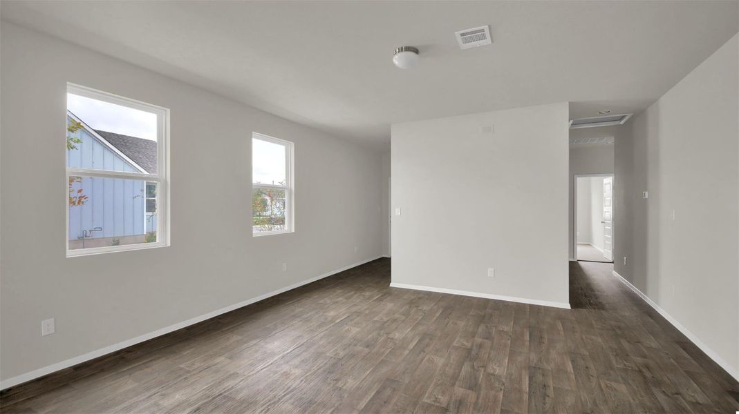 Unfurnished room featuring dark wood-style floors and baseboards