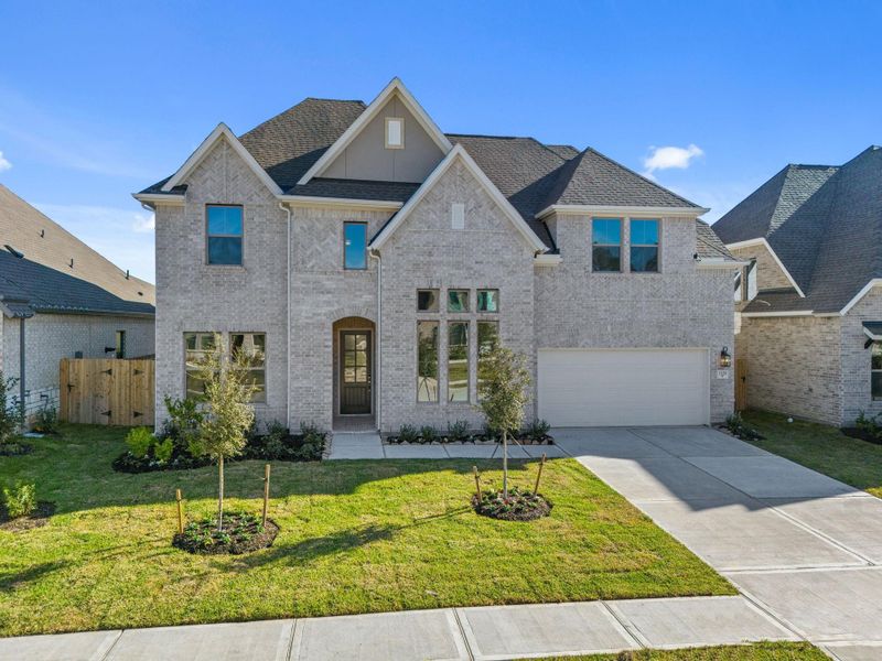 Front exterior of a new home in The Meadows at Imperial Oaks 60', Conroe, TX, highlighting curb appeal (Image 22).