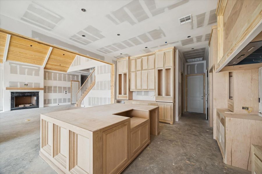 This view highlights the cooktop wall where the custom hood and Thermador appliances will anchor the kitchen. Generous counter space will be finished with premium slab surfaces for a refined, durable workspace. A thoughtfully planned culinary zone that brings beauty and performance together.