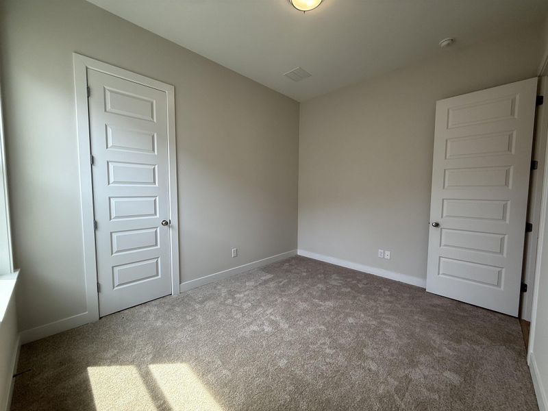 Empty room with carpet and baseboards