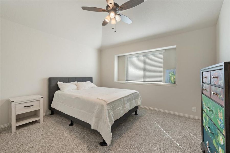 Secondary carpeted bedroom upstairs has a spacious closet, lofted ceiling and ceiling fan with light kit. All windows have brand new 2 inch cordless blinds.