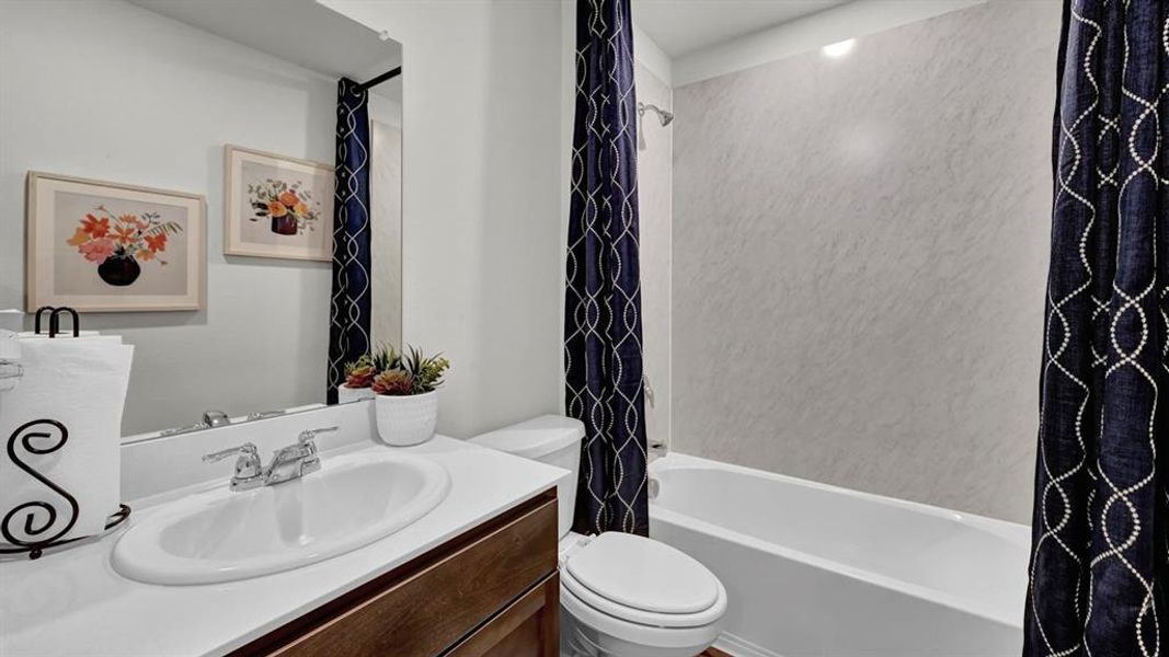 Bathroom with vanity and shower / tub combo