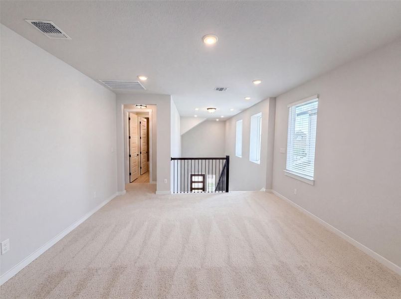 A spacious upstairs living area offers endless possibilities for relaxation or recreation. A spacious upstairs living area offers endless possibilities for relaxation or recreation.