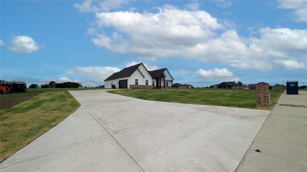 Front exterior of a new home in , Greenville, TX, highlighting curb appeal (Image 20).