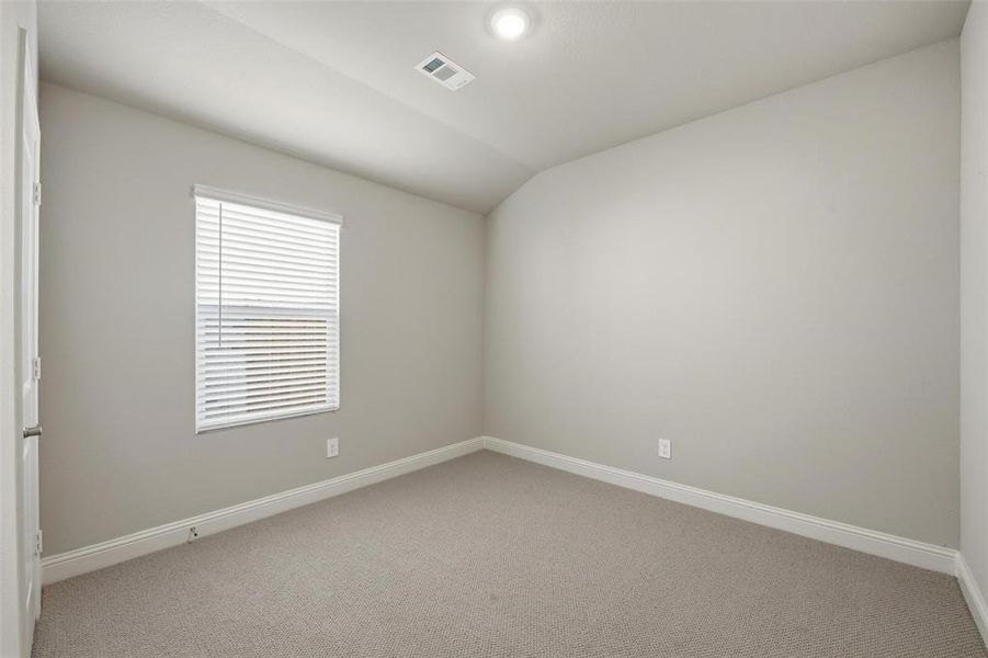 Empty room featuring carpet, vaulted ceiling, and recessed lighting