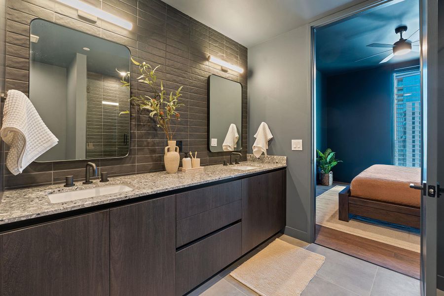 Primary bathroom with oversized floor tiles, a walk in shower, custom fixtures, and other luxurious features.