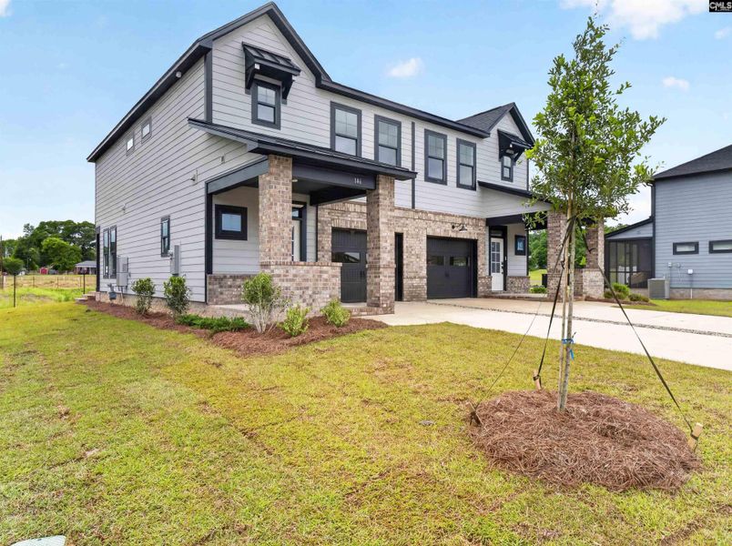 Front exterior of a new home in Dunbar Village, Cayce, SC, highlighting curb appeal (Image 2). Front exterior of a new home in Dunbar Village, Cayce, SC, highlighting curb appeal (Image 2).