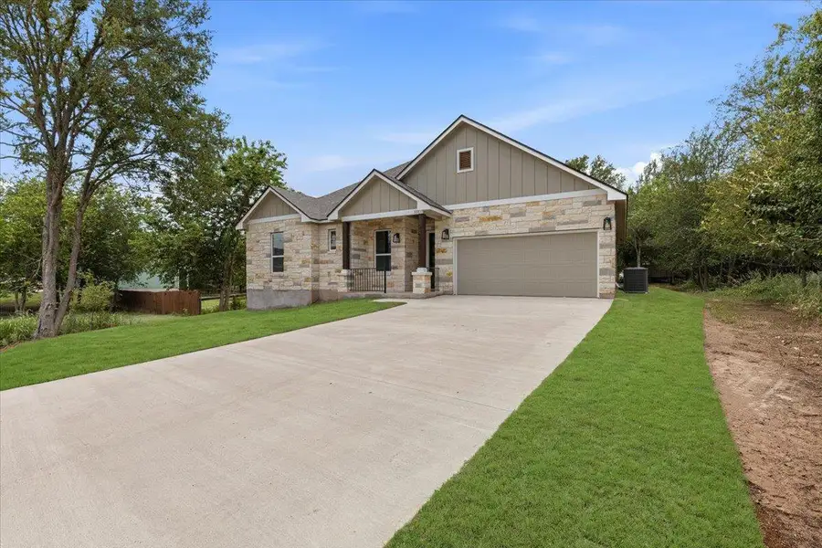 A well-maintained lawn and extended driveway lead to this charming home, showcasing a blend of natural stone and siding. A well-maintained lawn and extended driveway lead to this charming home, showcasing a blend of natural stone and siding.