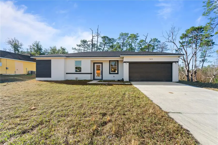Front exterior of a new home in , Deltona, FL, highlighting curb appeal (Image 18).