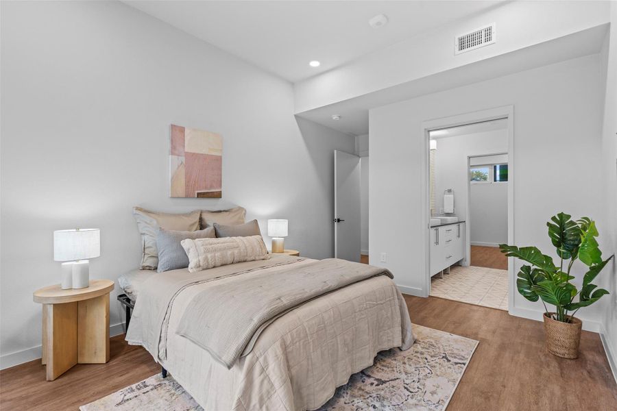 Bedroom featuring recessed lighting, wood finished floors, visible vents, and baseboards