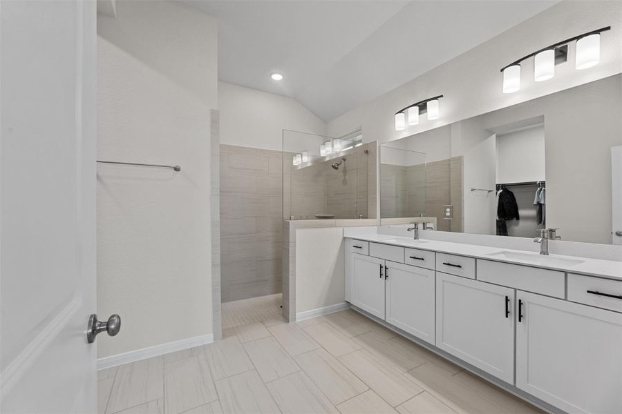 The primary bathroom is huge! It has to be to fit this large shower, vanity with lots of storage and counter space! The mirror gives you a glimpse of the closet. The primary bathroom is huge! It has to be to fit this large shower, vanity with lots of storage and counter space! The mirror gives you a glimpse of the closet.