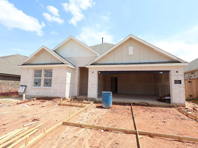 Front exterior of a new home in Magnolia Ridge, Magnolia, TX, highlighting curb appeal (Image 2).
