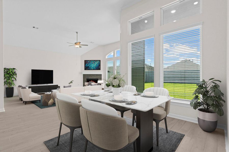 Bright and airy family room featuring multiple large windows and a gas fireplace, ideal for hosting guests or enjoying quiet evenings. *Virtually Staged*