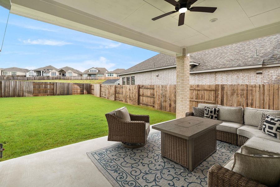 A spacious covered patio offers a comfortable retreat with ample yard space and privacy fencing.