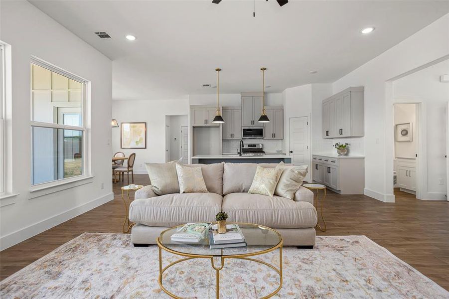 Living room featuring ceiling fan and dark hardwood / wood-style floors